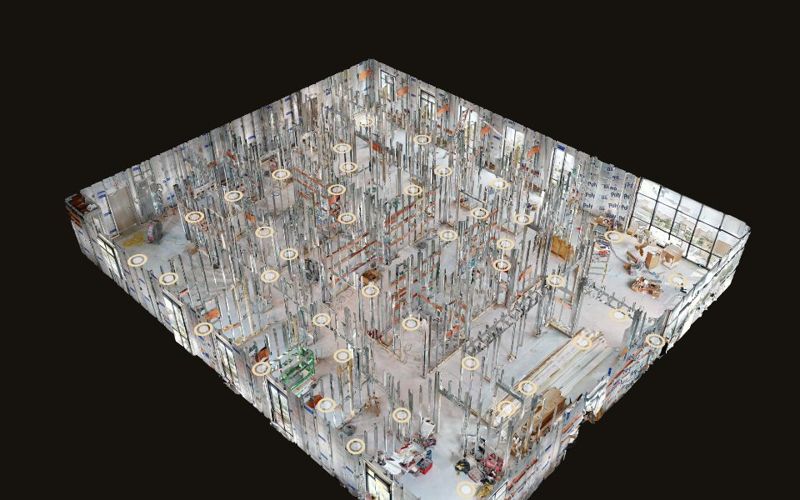 Dollhouse view of a building under construction, showing steel stud framing and gold scan positions